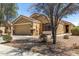 View of the home's facade, showcasing its neutral color palette and attached two-car garage at 23749 W Grove St, Buckeye, AZ 85326