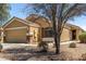 View of the home's facade, showcasing its neutral color palette and attached two-car garage at 23749 W Grove St, Buckeye, AZ 85326
