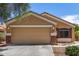 Single-story home with a two-car garage and manicured landscaping offering curb appeal at 23749 W Grove St, Buckeye, AZ 85326