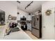 Well-lit kitchen with stainless steel appliances, light blue cabinets and quartz countertops at 23749 W Grove St, Buckeye, AZ 85326