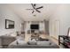 Spacious living room featuring tile flooring, a ceiling fan, and neutral wall colors at 23749 W Grove St, Buckeye, AZ 85326