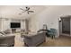 Bright living room featuring tile flooring, a ceiling fan, and neutral wall colors at 23749 W Grove St, Buckeye, AZ 85326