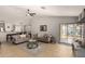 Bright living room with tile flooring, a ceiling fan, and a glass sliding door to the exterior at 23749 W Grove St, Buckeye, AZ 85326