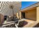 Outdoor patio area with a dining table, chairs, and grill for entertaining guests at 23749 W Grove St, Buckeye, AZ 85326