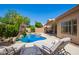 Inviting backyard with sparkling pool, lounge chairs, desert landscaping, and stucco home exterior at 251 E Arabian Dr, Gilbert, AZ 85296
