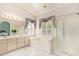 Bright bathroom featuring double sinks, a soaking tub, and a glass-enclosed shower at 251 E Arabian Dr, Gilbert, AZ 85296