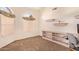 Bedroom with neutral carpet features window, desk, and built in shelves at 251 E Arabian Dr, Gilbert, AZ 85296