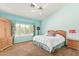 Bright bedroom featuring a ceiling fan, plush carpeting, and wooden furniture at 251 E Arabian Dr, Gilbert, AZ 85296