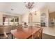 Elegant dining area with a chandelier, hardwood floors, and comfortable seating at 251 E Arabian Dr, Gilbert, AZ 85296
