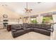 Open-concept living area with a ceiling fan, large windows, and tile flooring at 251 E Arabian Dr, Gilbert, AZ 85296