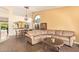 Cozy living area with a chandelier, comfortable seating, and views into the dining area at 251 E Arabian Dr, Gilbert, AZ 85296