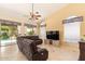 Bright living room with a ceiling fan, sliding glass doors to the pool, and tiled floors at 251 E Arabian Dr, Gilbert, AZ 85296