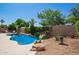 Backyard pool features lush landscaping, rock features, tanning ledge, and cool, clear blue water at 251 E Arabian Dr, Gilbert, AZ 85296