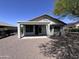 This backyard features a covered patio and easy-to-maintain desert landscaping for outdoor enjoyment at 26747 W Pontiac Dr, Buckeye, AZ 85396