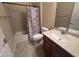 Cozy bathroom featuring a shower-tub combo, vanity, and tiled floors at 26747 W Pontiac Dr, Buckeye, AZ 85396