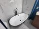 Modern bathroom with a sleek, freestanding bathtub and stylish tile at 26747 W Pontiac Dr, Buckeye, AZ 85396
