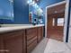 Stylish bathroom featuring double sinks, modern lighting, and marble flooring at 26747 W Pontiac Dr, Buckeye, AZ 85396