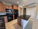 Bright kitchen featuring granite countertops, wood cabinetry, and stainless steel appliances at 26747 W Pontiac Dr, Buckeye, AZ 85396