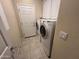 Convenient laundry room with white cabinets and modern washer and dryer units at 26747 W Pontiac Dr, Buckeye, AZ 85396