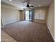 Open living space with carpet flooring, neutral walls, and a sliding glass door to the outside at 26747 W Pontiac Dr, Buckeye, AZ 85396