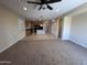 Bright and airy living space open to the kitchen with carpet flooring at 26747 W Pontiac Dr, Buckeye, AZ 85396