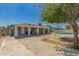 View of backyard including covered patio, fenced area with trampoline, and a low-pitched roof at 2908 N 54Th Dr, Phoenix, AZ 85031