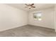 Cozy bedroom boasts a ceiling fan and a window providing natural light, complemented by modern flooring at 2908 N 54Th Dr, Phoenix, AZ 85031