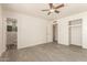 Inviting bedroom featuring a ceiling fan, closet, and ensuite bathroom with stylish green tile accents at 2908 N 54Th Dr, Phoenix, AZ 85031