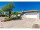 Exterior view of home with well-maintained lawn, two-car garage and mature trees, providing curb appeal at 2908 N 54Th Dr, Phoenix, AZ 85031