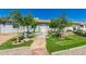 Charming front yard with lush lawn, fountain, mature trees, and welcoming walkway to the front door at 2908 N 54Th Dr, Phoenix, AZ 85031