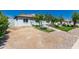 View of the front yard with green lawn and garden leading to a home featuring a well-maintained exterior at 2908 N 54Th Dr, Phoenix, AZ 85031
