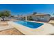 Backyard featuring an in-ground pool surrounded by concrete, landscaping, and fencing at 2908 N 54Th Dr, Phoenix, AZ 85031