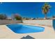 A refreshing in-ground swimming pool is surrounded by concrete and fencing in a private backyard at 2908 N 54Th Dr, Phoenix, AZ 85031