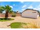 An inviting backyard features desert landscaping, grass, and palm trees at 3006 W Matthew Dr, Phoenix, AZ 85027
