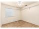A bright bedroom includes tile flooring, a ceiling fan, and window allowing plenty of natural light at 3006 W Matthew Dr, Phoenix, AZ 85027