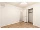Bright bedroom with tile floor, open closet, and view to the hallway at 3006 W Matthew Dr, Phoenix, AZ 85027