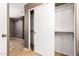 Bright bedroom closet featuring adjustable shelving behind a white sliding door and view of a tiled floor at 3006 W Matthew Dr, Phoenix, AZ 85027