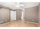 Neutral bedroom features tile floors, ceiling fan, closet, and two doors at 3006 W Matthew Dr, Phoenix, AZ 85027