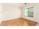 Cozy bedroom boasts beautiful hardwood floors and a window offering serene natural light at 3006 W Matthew Dr, Phoenix, AZ 85027