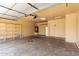 Spacious garage with an automatic door opener, water heater and storage shelves at 3006 W Matthew Dr, Phoenix, AZ 85027
