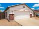 Close-up of the home's garage, complemented by brick accents and meticulous gravel landscaping at 3006 W Matthew Dr, Phoenix, AZ 85027