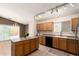 Well-lit kitchen with oak cabinetry, tile flooring, and a view to the outdoor patio at 3006 W Matthew Dr, Phoenix, AZ 85027