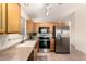 Bright kitchen showcasing modern stainless steel appliances, oak cabinets, and ample counter space at 3006 W Matthew Dr, Phoenix, AZ 85027