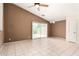 Open-concept living room with neutral tones, tile flooring, and sliding glass doors leading to outdoor space at 3006 W Matthew Dr, Phoenix, AZ 85027