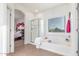 Bright bathroom features a soaking tub with a separate shower and a view to the bedroom at 3025 N Desert Horizons Ln, Casa Grande, AZ 85122