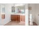 Bathroom vanity with double sinks, framed mirror and tile flooring at 3025 N Desert Horizons Ln, Casa Grande, AZ 85122