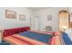 Bright bedroom with Southwestern-style bed, chair, and views of the hallway at 3025 N Desert Horizons Ln, Casa Grande, AZ 85122