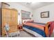 Cozy bedroom with wardrobe, Southwestern style bed, chair and nightstand at 3025 N Desert Horizons Ln, Casa Grande, AZ 85122