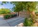 Two-story home with desert landscaping, a tan stucco exterior, a tile roof, and an attached two-car garage at 3025 N Desert Horizons Ln, Casa Grande, AZ 85122