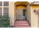 Covered front entrance with stucco walls, tiled steps, and a decorative security screen door at 3025 N Desert Horizons Ln, Casa Grande, AZ 85122
